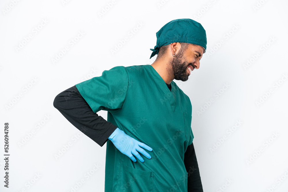 Surgeon Brazilian man in green uniform isolated on white background suffering from backache for having made an effort