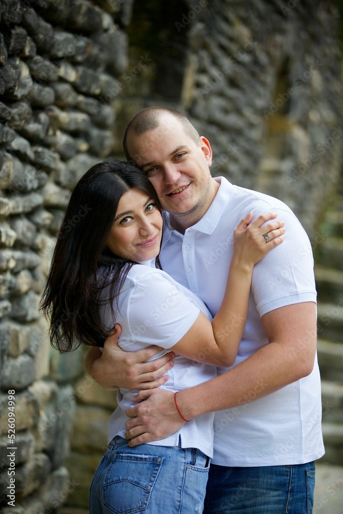 Lovers are in the Park at the stone wall.