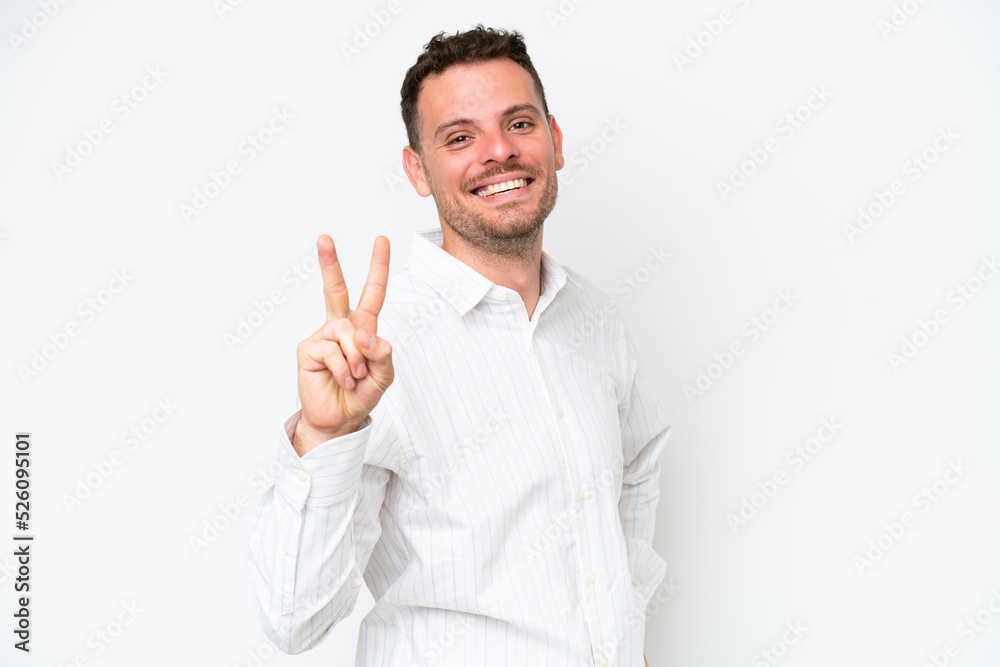 Young caucasian handsome man isolated on white background smiling and showing victory sign
