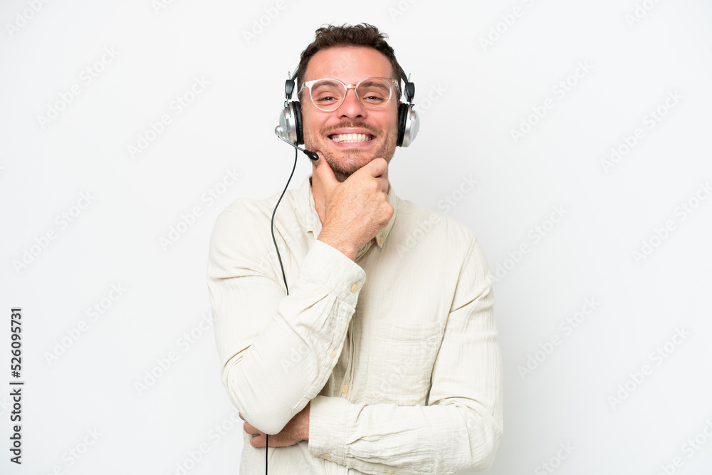 Telemarketer caucasian man working with a headset isolated on white background with glasses and smiling Telemarketer caucasian man working with a headset isolated on white background with glasses and smiling