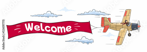 Flying advertising banner out by aircraft with the inscription Welcome