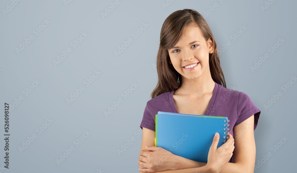 Happy smiling student or teacher. Student education in high school university college concept. Happy young girl holding notes Happy smiling student or teacher. Student education in high school university college concept. Happy young girl holding notes