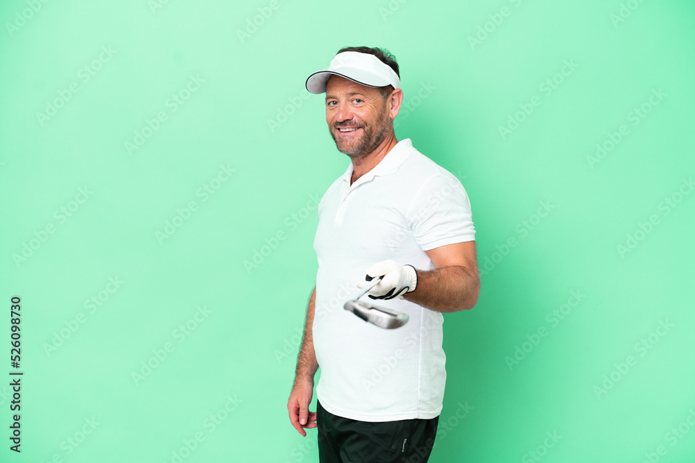 Middle age caucasian man isolated on green background playing golf