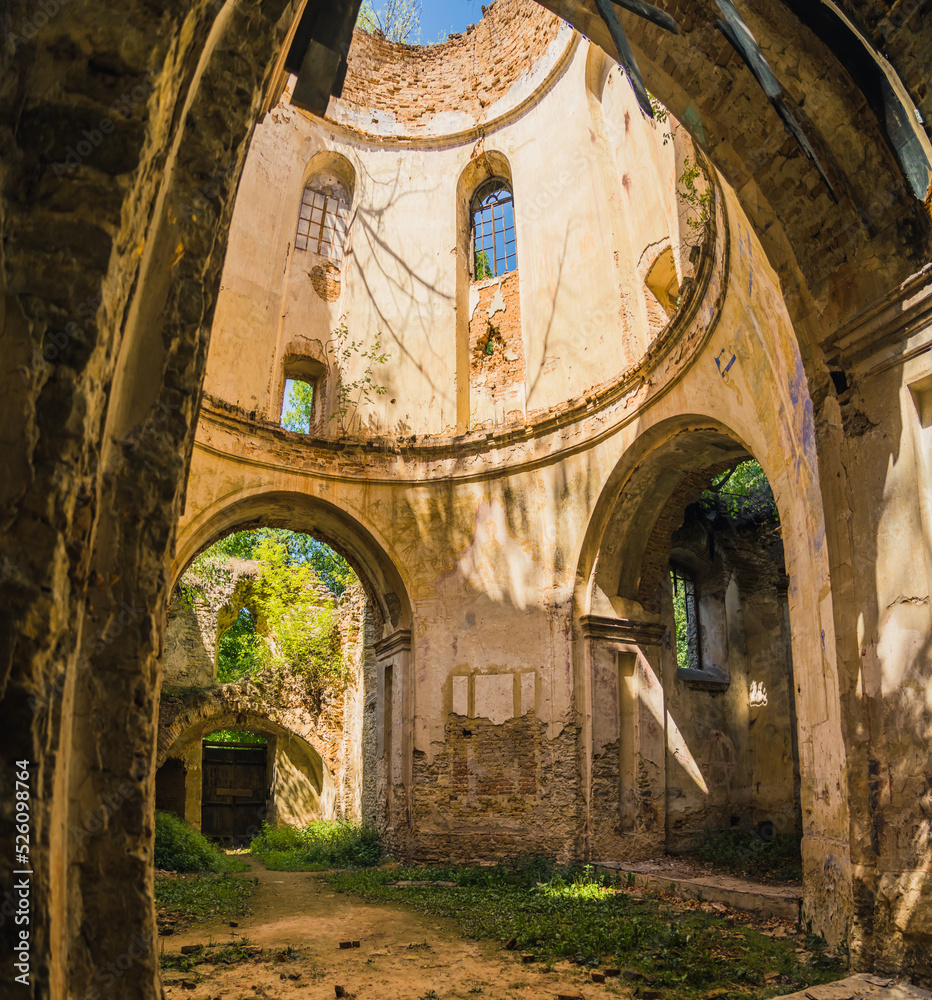 Weathered arches archways and windows of ruined old abandoned church in Lubycza Krolewska. Christian architecture. Vertical shot. High quality photo