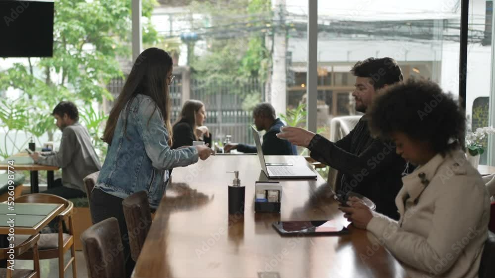 Group of people sitting inside coffee shop restaurant. Men and women sitting at cafe place Group of people sitting inside coffee shop restaurant. Men and women sitting at cafe place