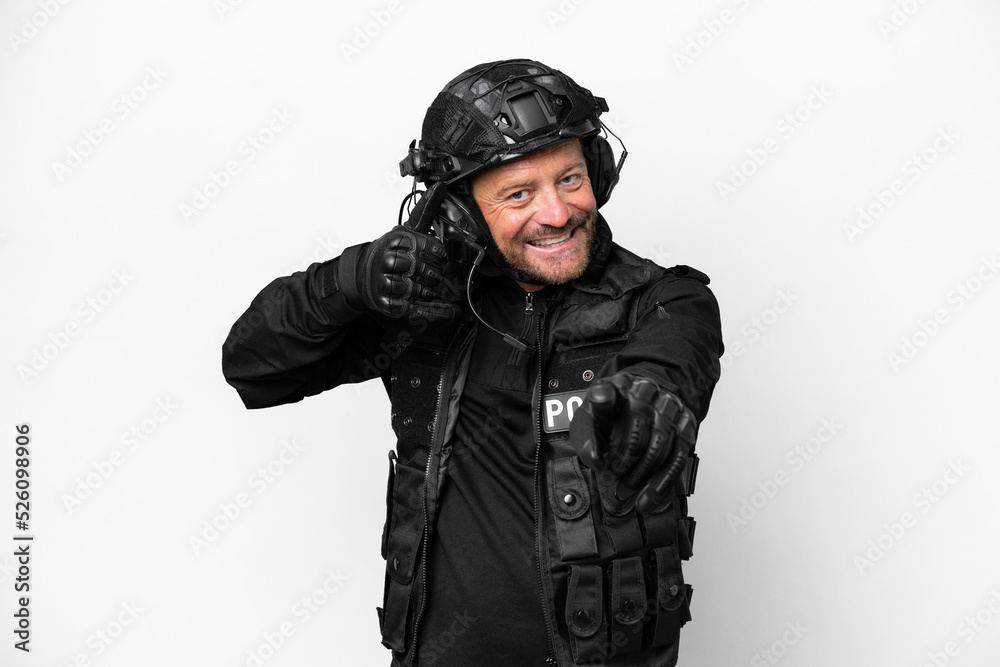Middle age SWAT man isolated on white background making phone gesture and pointing front Middle age SWAT man isolated on white background making phone gesture and pointing front