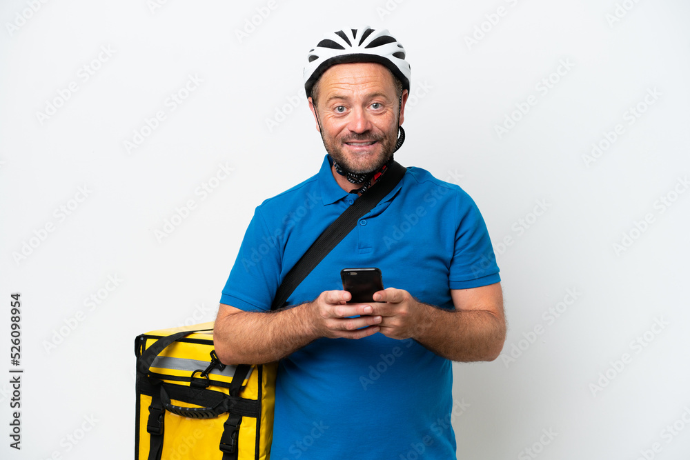 Middle age caucasian man with thermal backpack isolated on white background sending a message with the mobile Middle age caucasian man with thermal backpack isolated on white background sending a message with the mobile