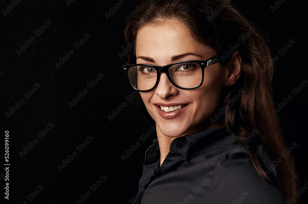 Beautiful happy toothy smiling business woman in blue shirt on black background. Closeup positive portrait. Toned Beautiful happy toothy smiling business woman in blue shirt on black background. Closeup positive portrait. Toned