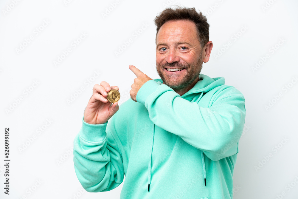 Middle age man holding a Bitcoin over isolated background pointing back Middle age man holding a Bitcoin over isolated background pointing back