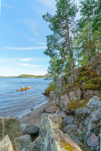 Beautiful stones and pine trees on the lake. Landscape of wild nature.