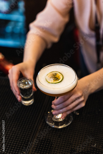 bartender holding shot and martini drink