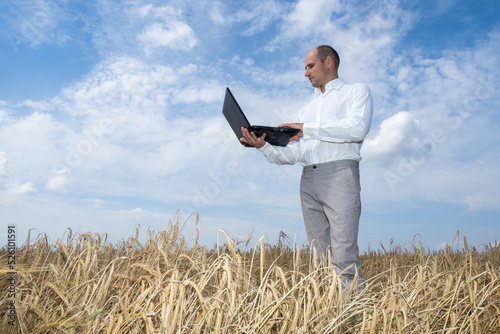 Businessman in field with g...