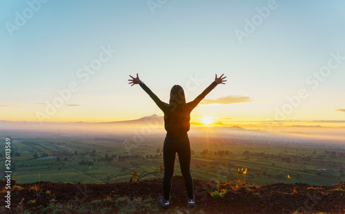 strong confidence woman open arms under the sunrise at mountain