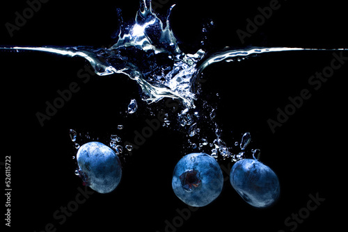 Fresh blueberries splashed in water on black © Katie Chizhevskaya