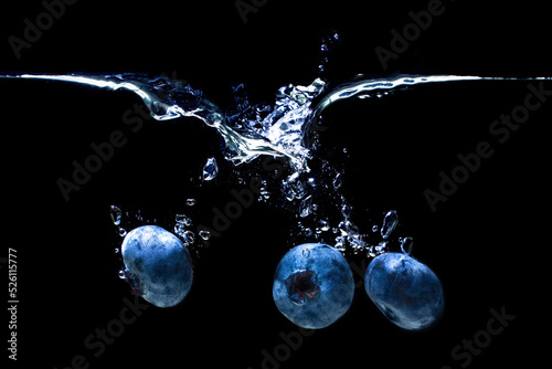 Blueberries sinking underwater with air bubbles