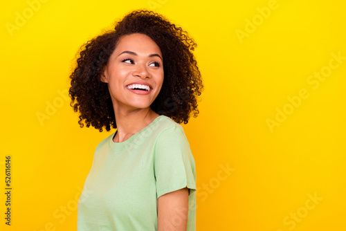 Profile photo of optimistic brunette curly lady look promotion wear green t-shirt isolated on vivid yellow color background
