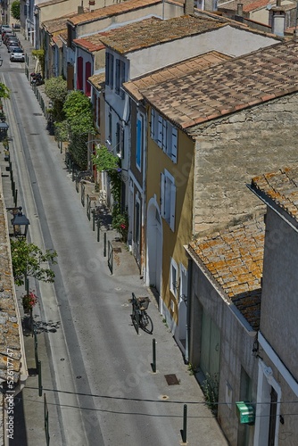 Vertical low-angle shot of 0ld roofs of old buildings in Aigues-Mortes, Gard, France photo