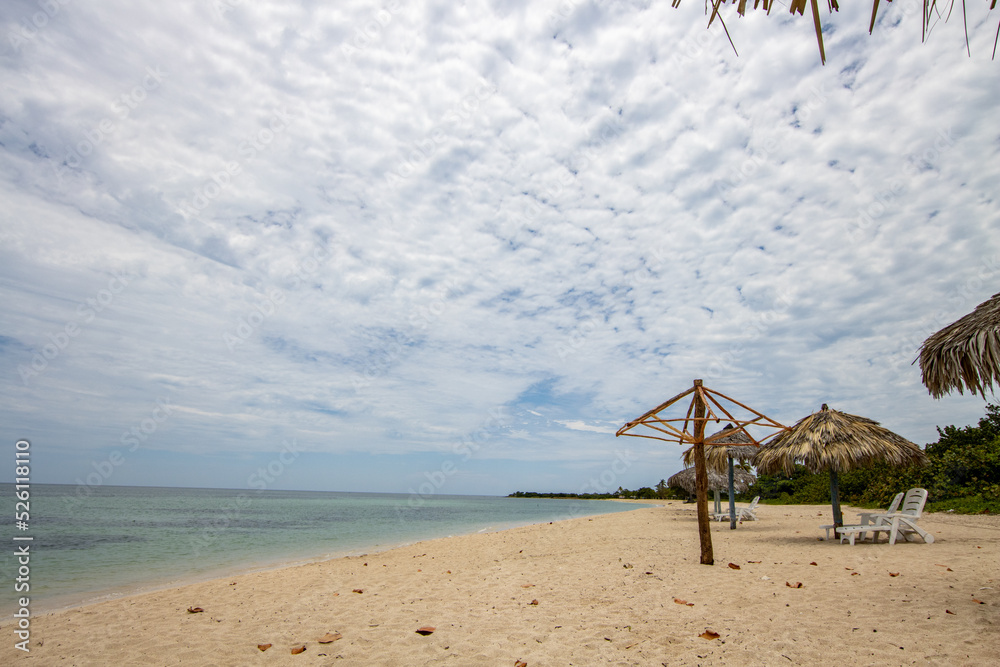 Caribbean beach with crystal clear sea and sand. Relaxation and tourism in the Caribbean. Beach umbrella made of palm leaves. Caribbean resort and luxury experience tranquil and relax Caribbean beach with crystal clear sea and sand. Relaxation and tourism in the Caribbean. Beach umbrella made of palm leaves. Caribbean resort and luxury experience tranquil and relax