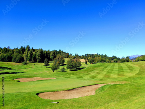 Panoramic view of golf course in Argentine Patagonia under blue sky. Nature and outdoor sports.