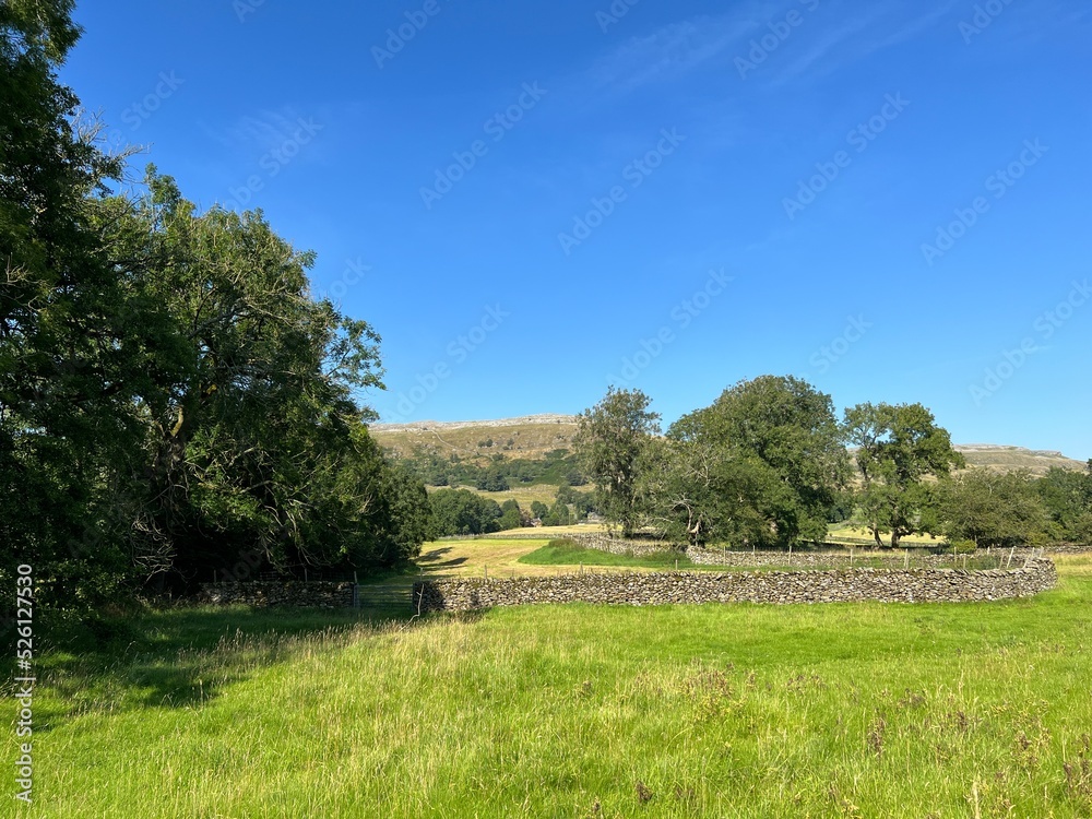 Rural landscape near, Wood Lane, with fields, dry stone walls, and distant hills near, Austwick, UK Rural landscape near, Wood Lane, with fields, dry stone walls, and distant hills near, Austwick, UK