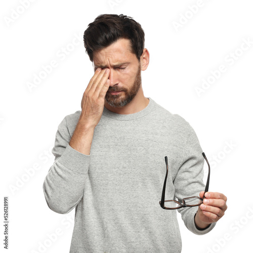 Man suffering from eyestrain on white background photo