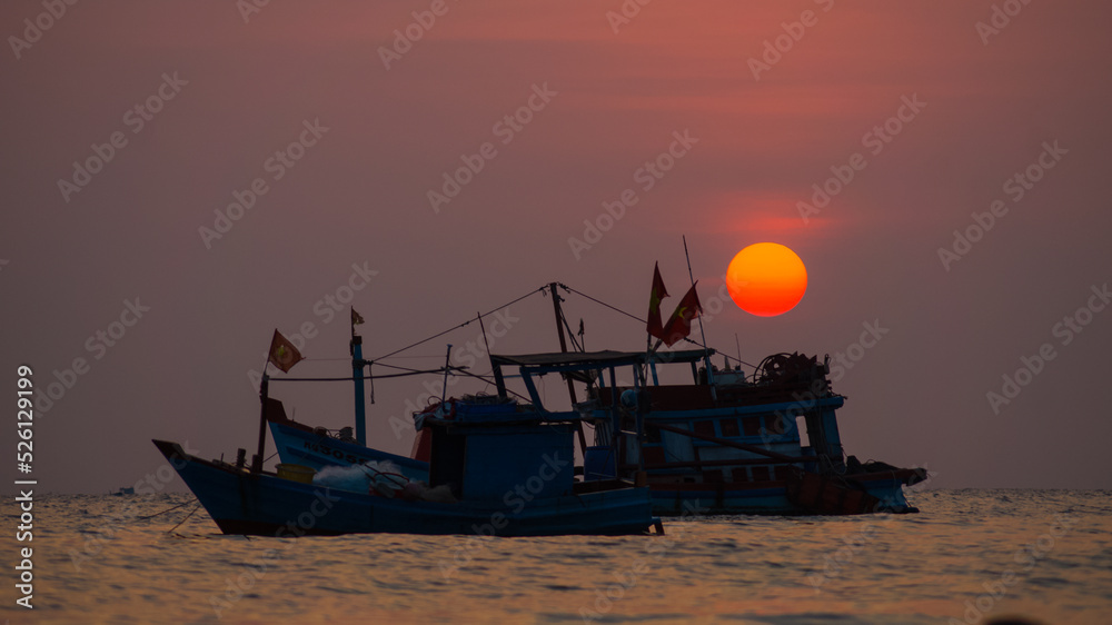 Vietnamese boats on the background of sunset at sea. Phu Quoc Island. Vietnam. The Gulf of Thailand. The South China Sea. 