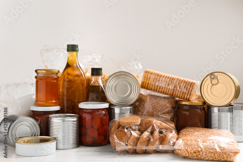 Different products on white wooden table. Food donation