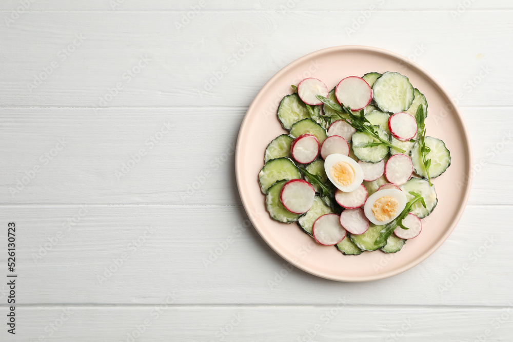 Tasty fresh salad with cucumber on white wooden table, top view. Space for text Tasty fresh salad with cucumber on white wooden table, top view. Space for text
