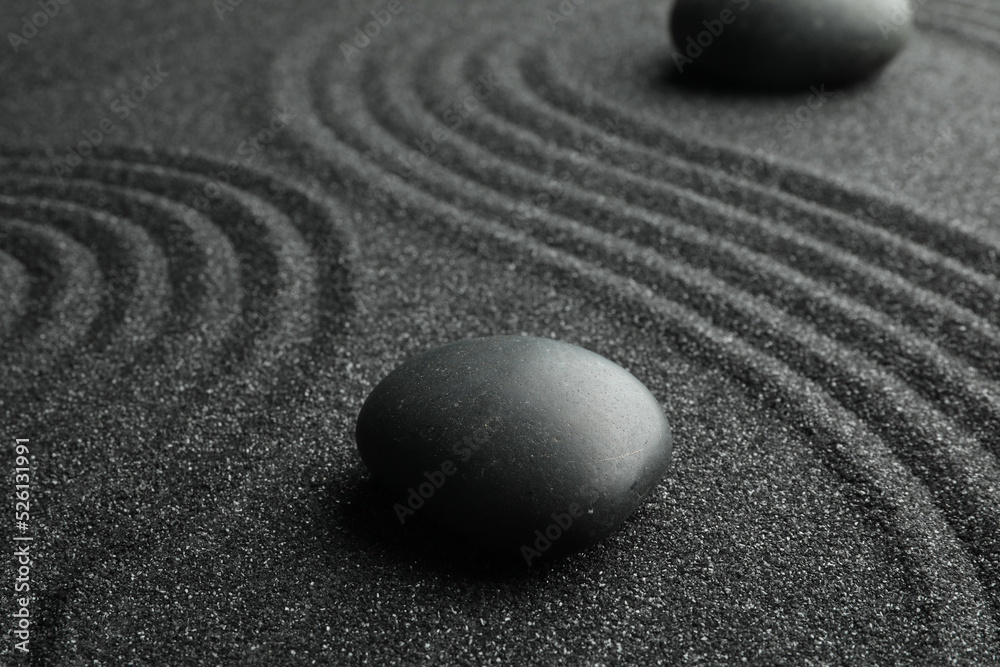 Fototapeta premium Black sand with stones and beautiful pattern. Zen concept