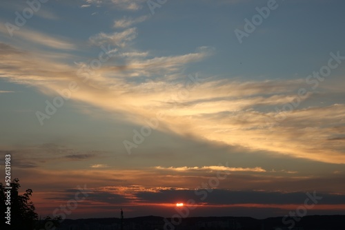 Picturesque view of cityscape and beautiful sky with clouds at sunset