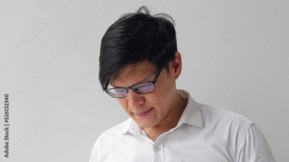 Unhappy asian office worker hold mobile phone in hand call complaint to customer service. Unhappy asian office worker hold mobile phone in hand call complaint to customer service.