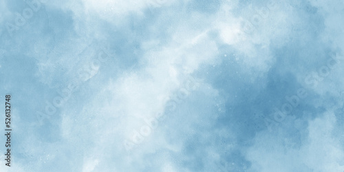 Abstract blue watercolor painted mottled blue background with vintage marbled textured design on cloudy sky blue banner panoramic background.
