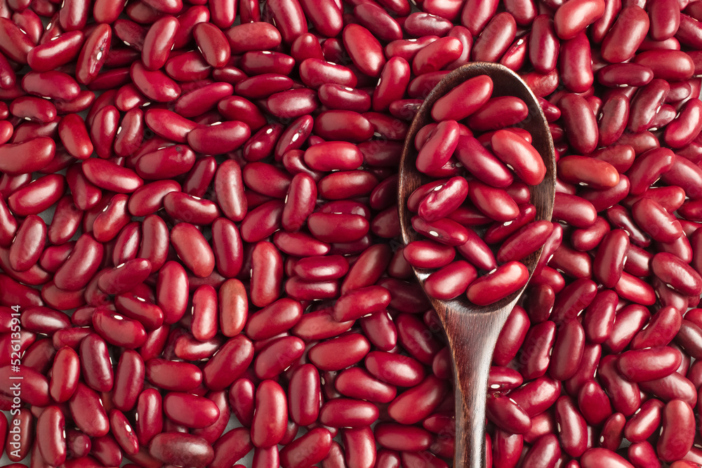 Close-up photo of several red kidney beans and wooden spoon,top view,flay lay,top-down. Close-up photo of several red kidney beans and wooden spoon,top view,flay lay,top-down.