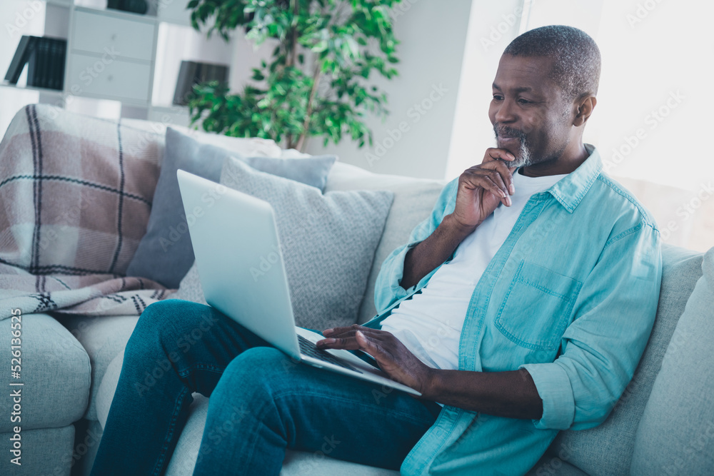 Photo of minded aged man manager boss sit couch use netbook analyze colleagues report lockdown time in modern house Photo of minded aged man manager boss sit couch use netbook analyze colleagues report lockdown time in modern house