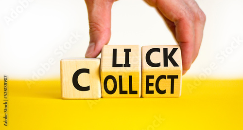 Click and collect symbol. Concept words Click and Collect on wooden cubes. Businessman hand. Beautiful yellow table white background. Click and collect and business concept. Copy space.
