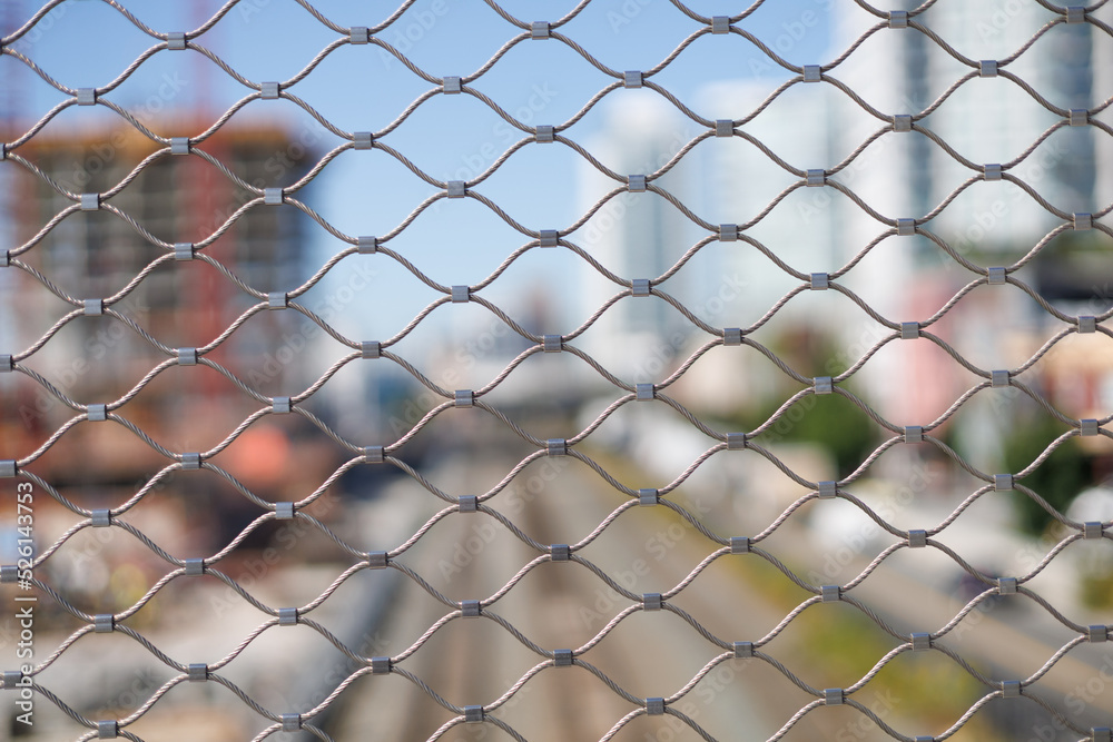 chain linked fence with city in background. chain linked fence with city in background.