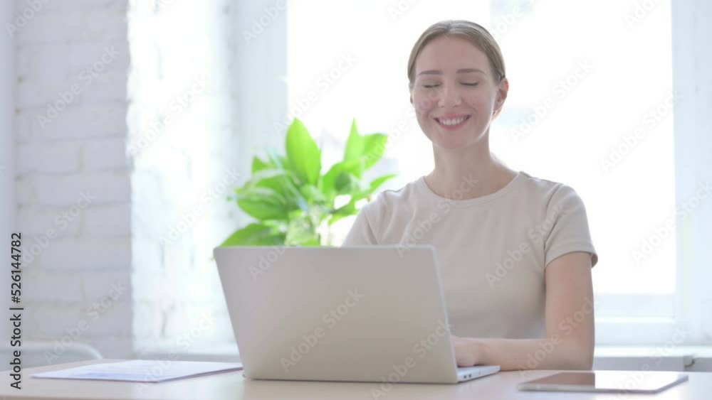 Shaking Head in Acceptance, Approval by Woman Working on Laptop Shaking Head in Acceptance, Approval by Woman Working on Laptop