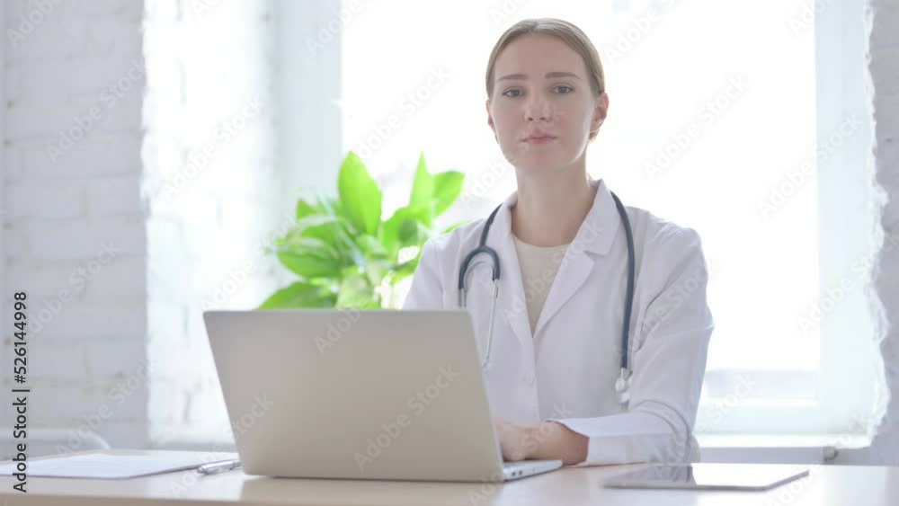 Lady Doctor Looking at Camera While sitting in Clinic Lady Doctor Looking at Camera While sitting in Clinic