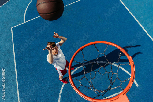 top view of young man playing basketball on modern court © LIGHTFIELD STUDIOS
