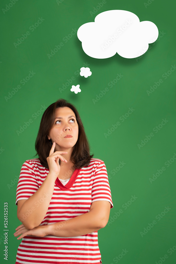 Clouds of thought  with overweight woman in a thoughtful face on green background