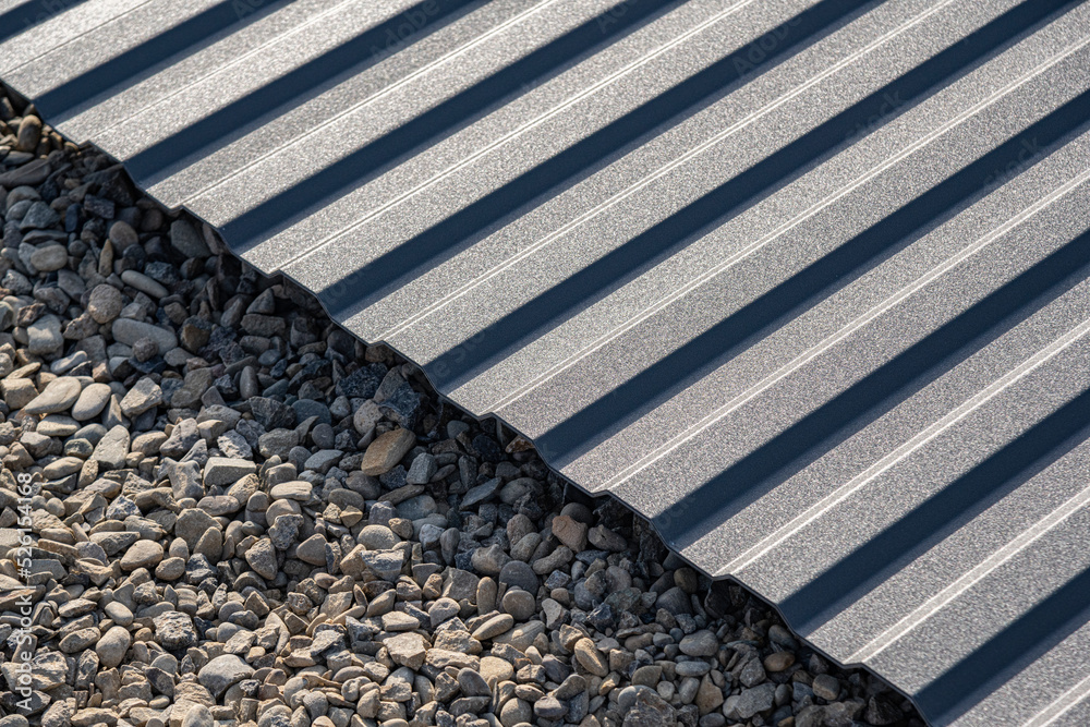 A sheet of corrugated board lies on rubble.