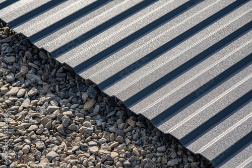 A sheet of corrugated board lies on rubble.