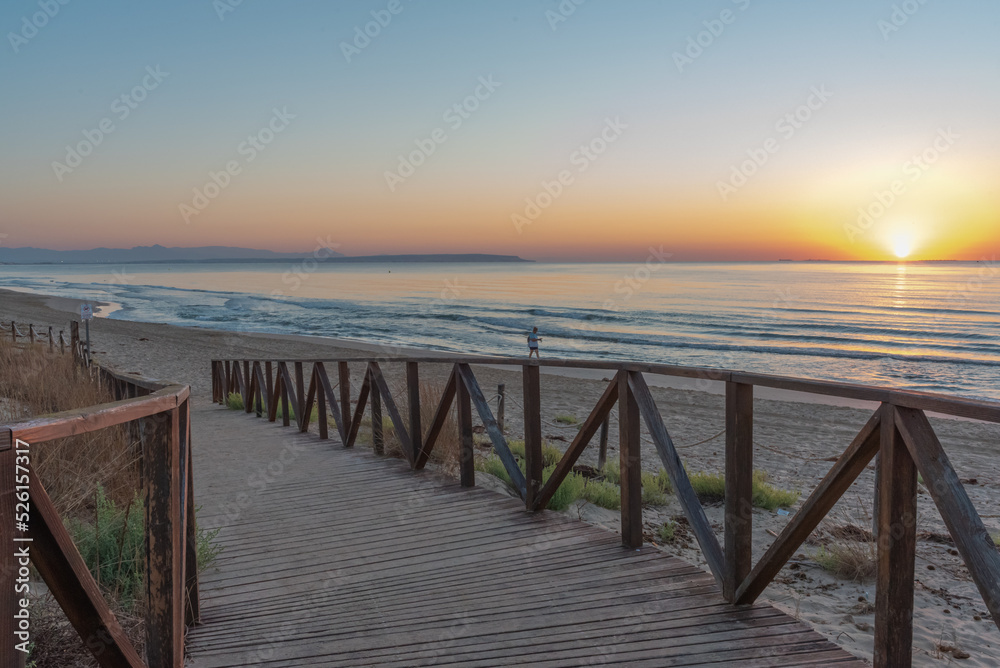 Sunrise on the wooden boardwalks of the beach