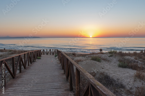 Sunrise on the wooden boardwalks of the beach