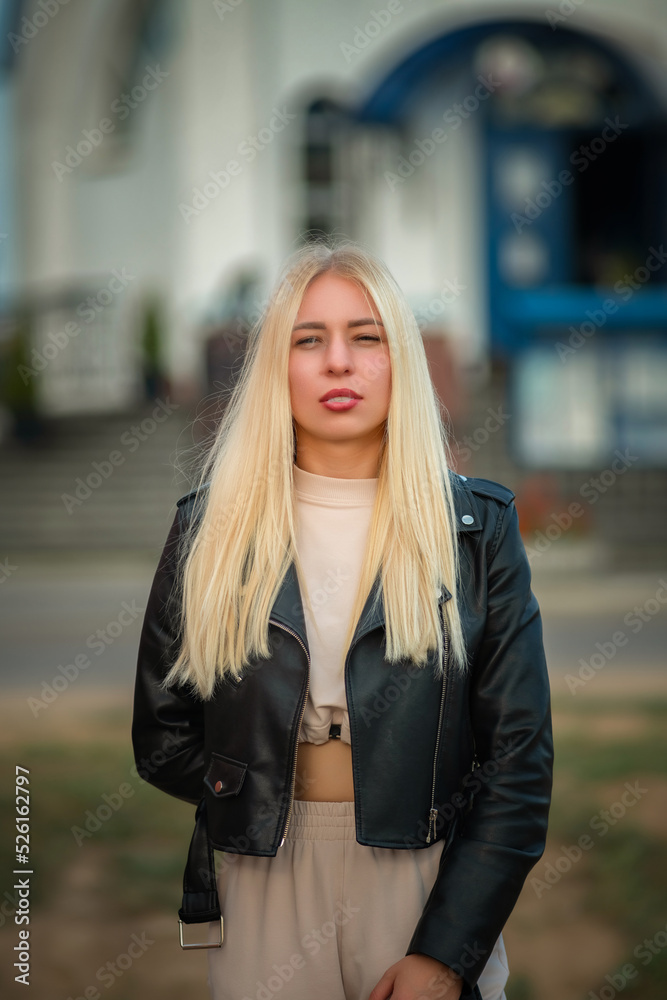 Portrait of a young beautiful fair-haired girl letting out cigarette smoke from her mouth. Portrait of a young beautiful fair-haired girl letting out cigarette smoke from her mouth.