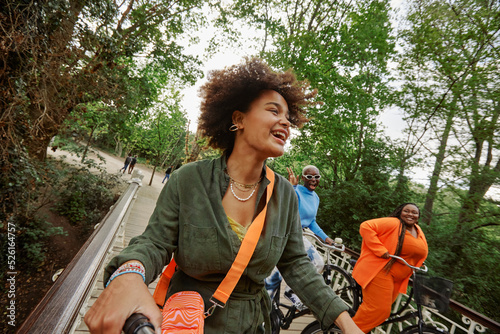 фотографія Happy female friends riding bicycles on bridge in Vondelpark