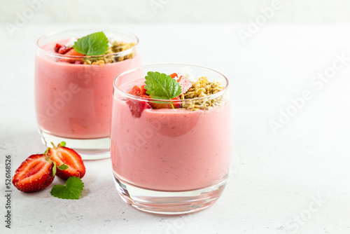 Srawberry yogurt parfait in glasses. Copy space, flat lay.