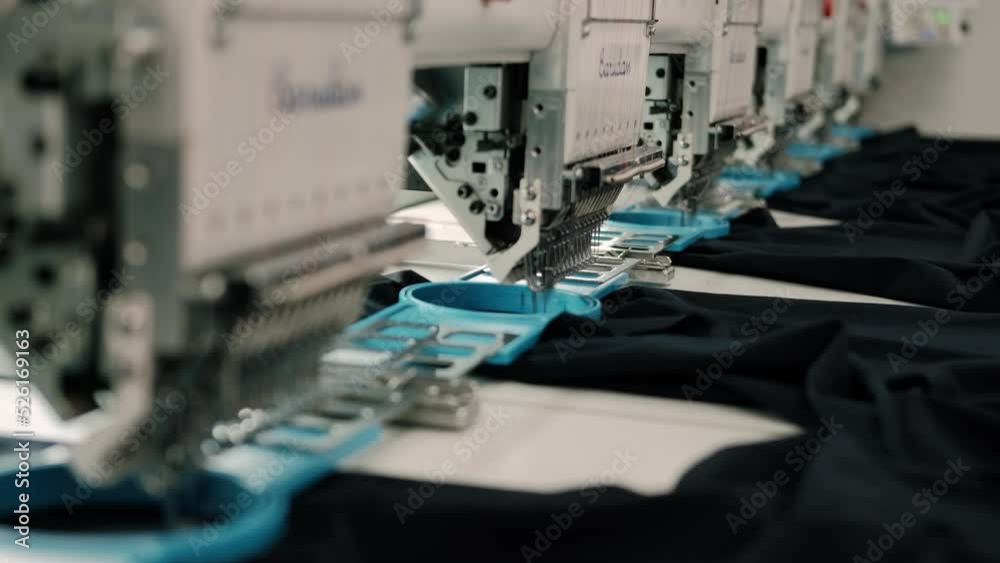 Modern and automatic high technology sewing machine for textile or clothing apparel making manufacturing process in industrial. Close up Computerized embroidery machines