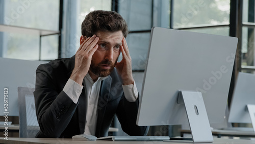 Caucasian bearded 40s middle-aged businessman worker employee man typing laptop feel failure upset with lost of information online error stressed look at computer screen suffer from headache pressure