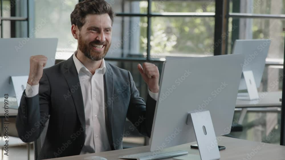 Happy Caucasian bearded businessman in office looking at computer screen with emotion winner cheerful rejoice with online win financial betting growth man worker CEO overjoyed celebrating success Happy Caucasian bearded businessman in office looking at computer screen with emotion winner cheerful rejoice with online win financial betting growth man worker CEO overjoyed celebrating success